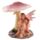 Sitzende Blumenfee unter einem Pilz