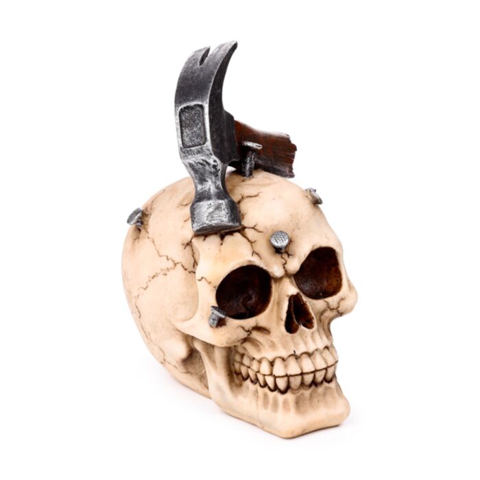 Totenkopf mit Metallhammer und Nägeln im Schädel